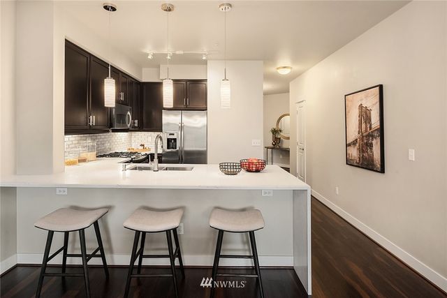 a kitchen with cabinets and chairs