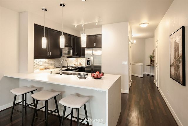 a kitchen with stainless steel appliances a sink stove and refrigerator