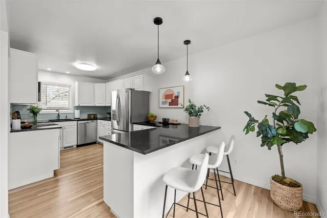 a kitchen with counter top space cabinets and appliances