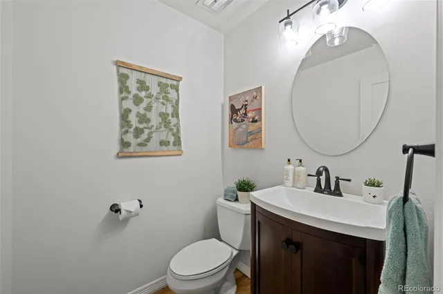 a bathroom with a toilet a sink and mirror