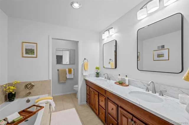 a bathroom with double vanity sinks and a mirror