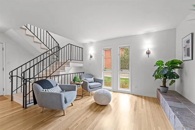 a living room with furniture and a potted plant