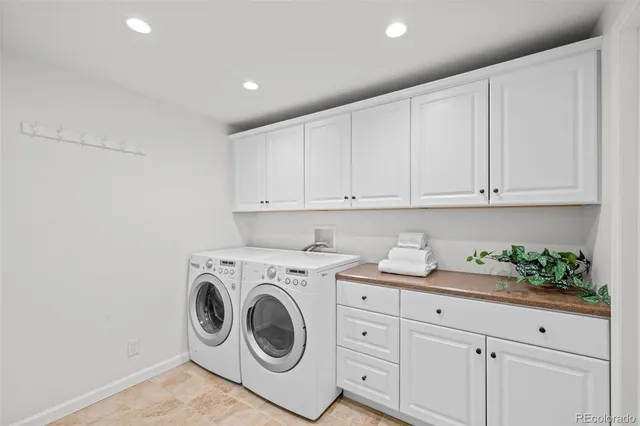 a utility room with sink dryer and washer