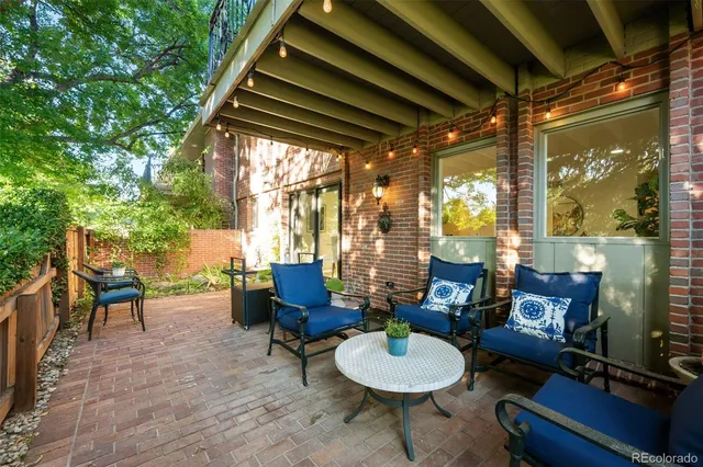 a backyard of a house with table and chairs