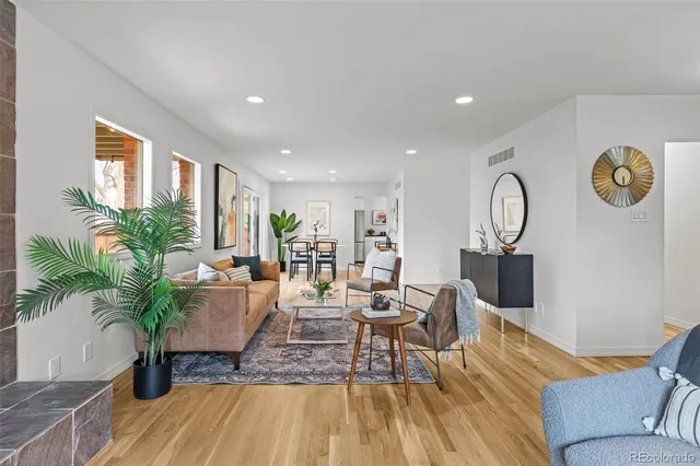 a living room with furniture and a clock