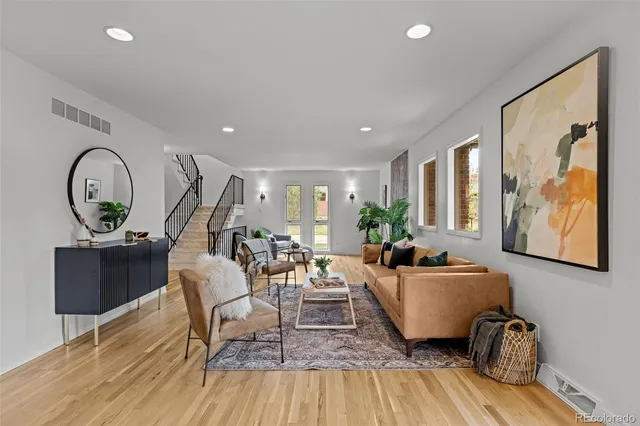 a living room with furniture a rug and a large window