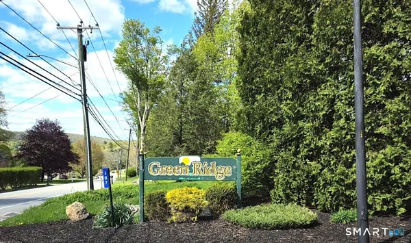a sign that is sitting in front of a house