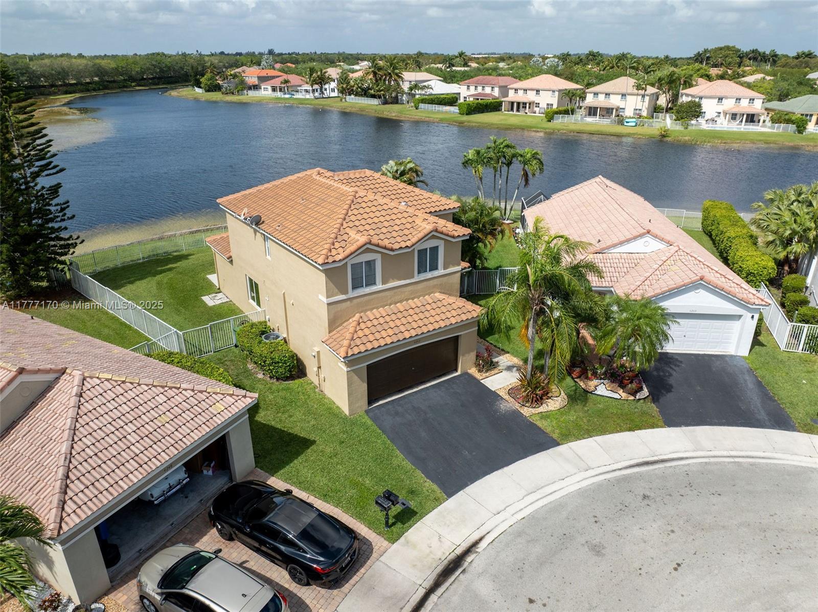 4242 Magnolia Ridge Drive Weston, FL 33331 - Photo 1 of 36 an aerial view of a house with a lake view