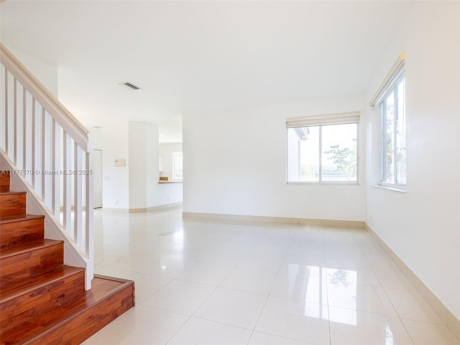 4242 Magnolia Ridge Drive Weston, FL 33331 - Photo 11 of 36 a view of an empty room with wooden floor and a window