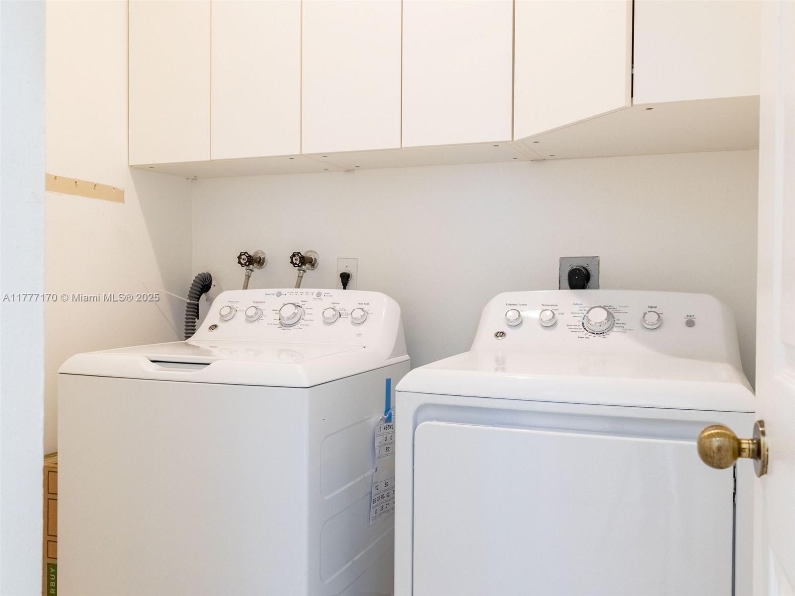 4242 Magnolia Ridge Drive Weston, FL 33331 - Photo 18 of 36 a utility room with dryer and washer