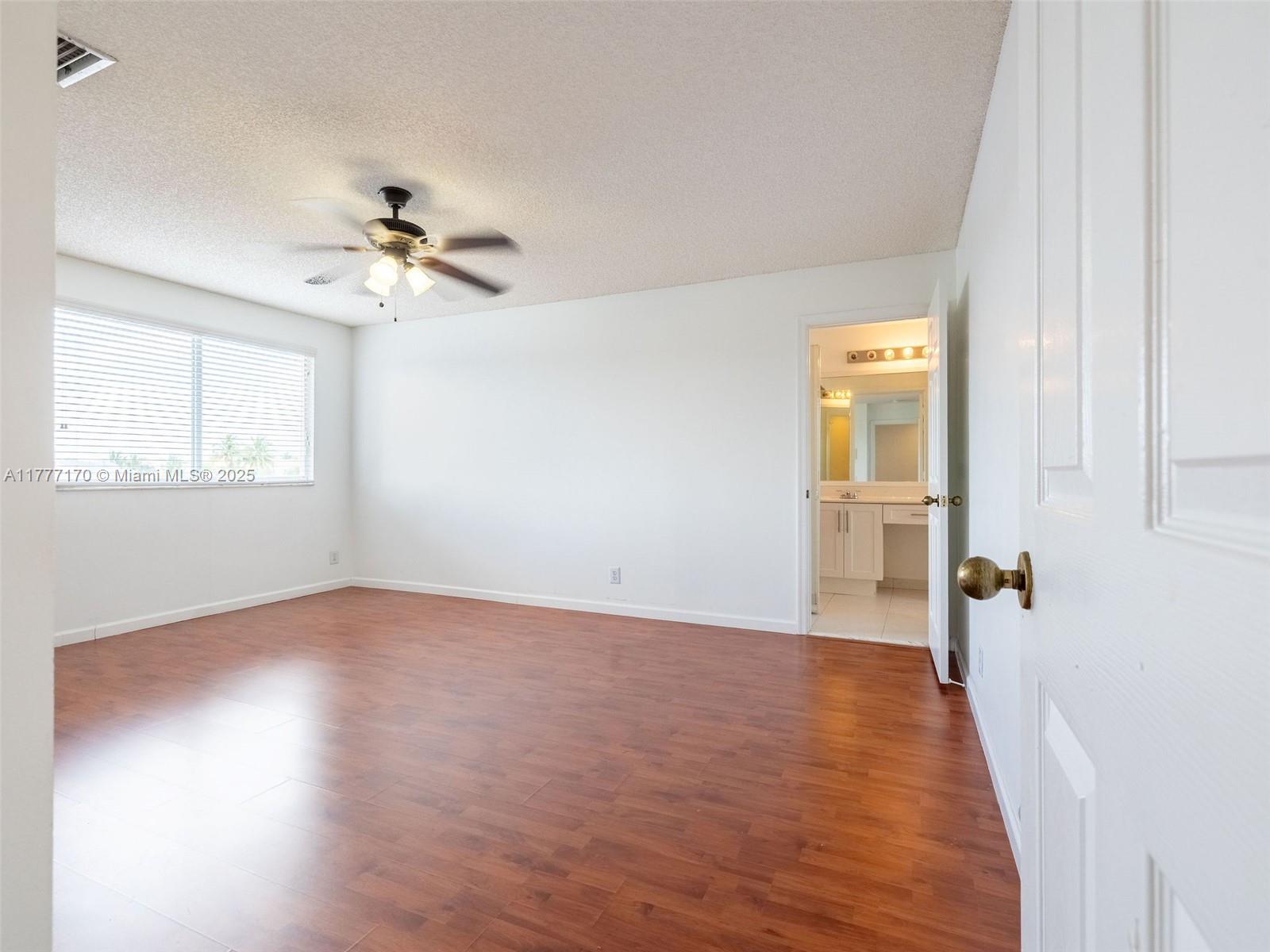 4242 Magnolia Ridge Drive Weston, FL 33331 - Photo 20 of 36 a view of empty room with wooden floor and fan