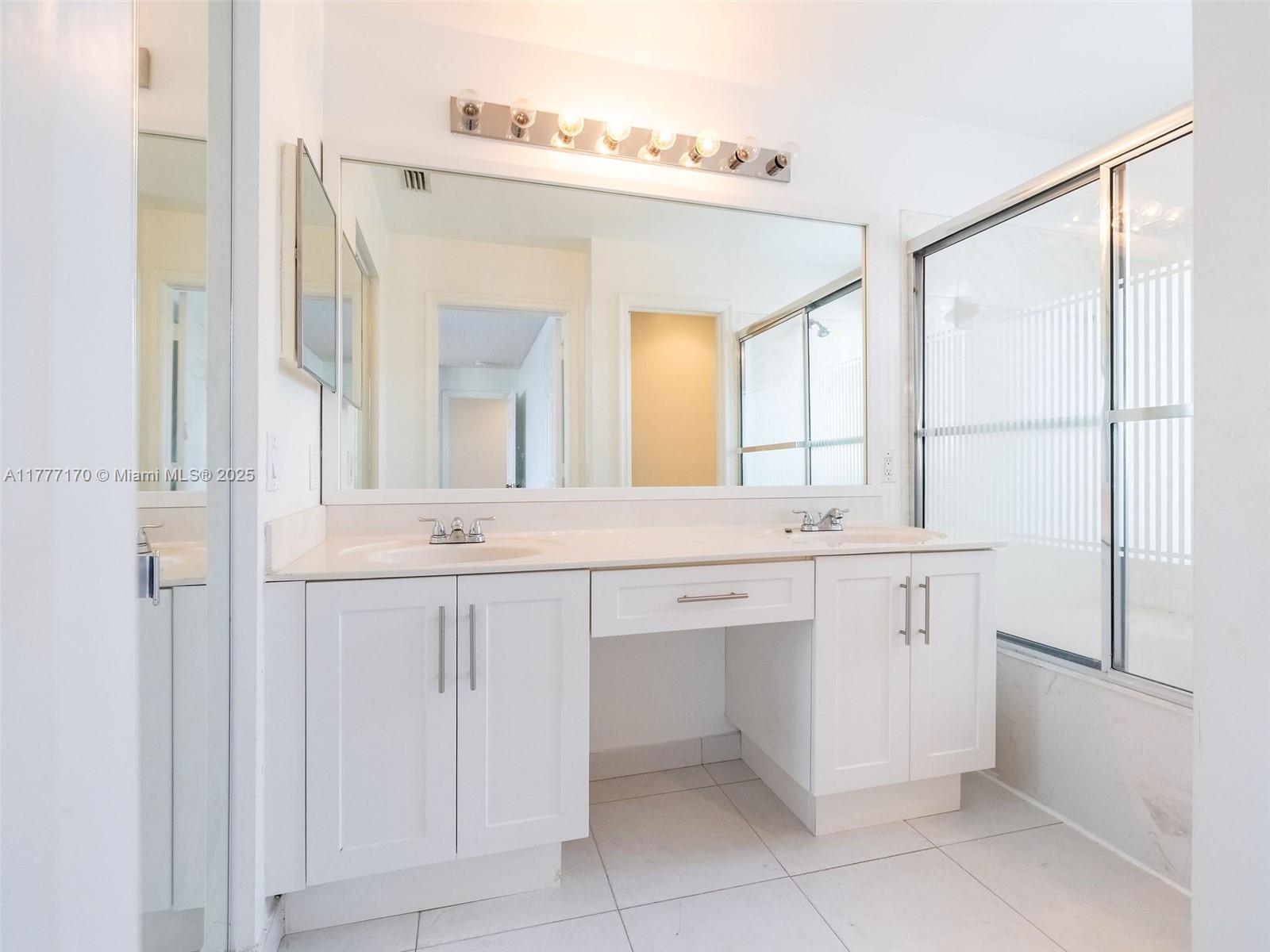 4242 Magnolia Ridge Drive Weston, FL 33331 - Photo 21 of 36 a bathroom with a double vanity sink and a mirror