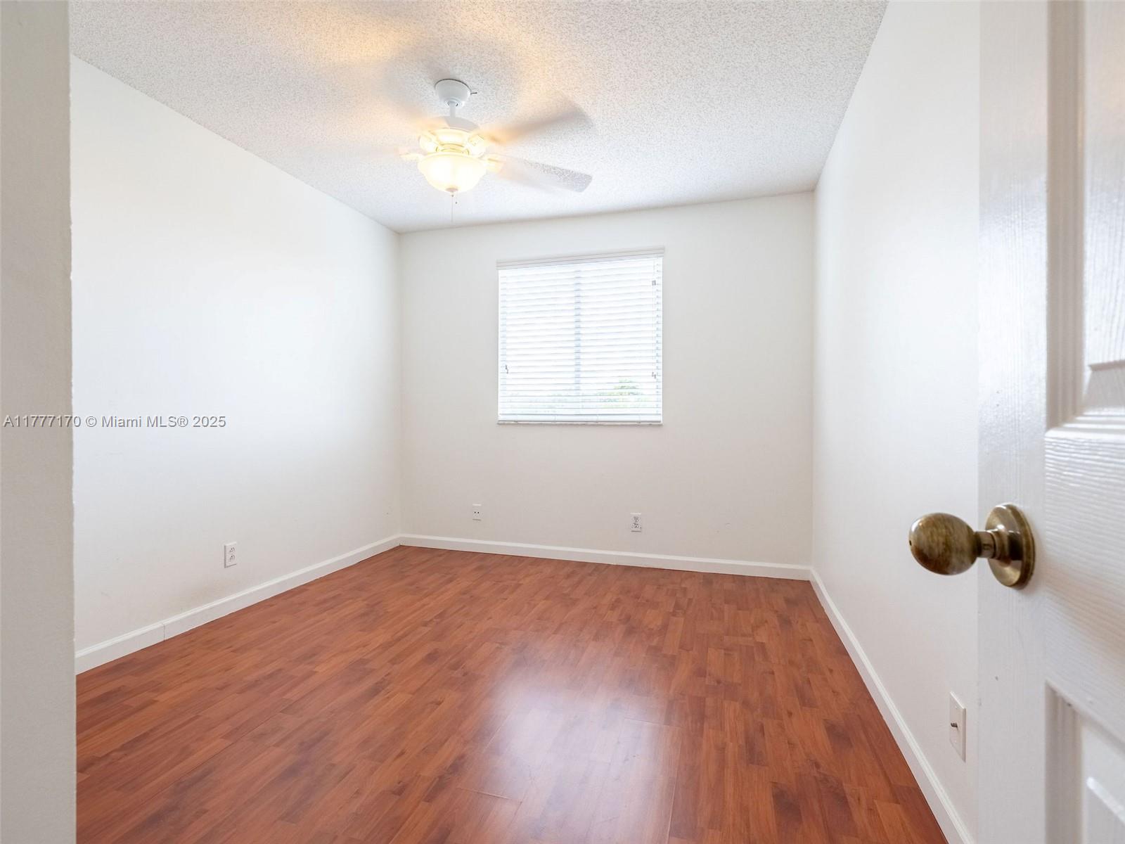 4242 Magnolia Ridge Drive Weston, FL 33331 - Photo 24 of 36 an empty room with wooden floor and windows