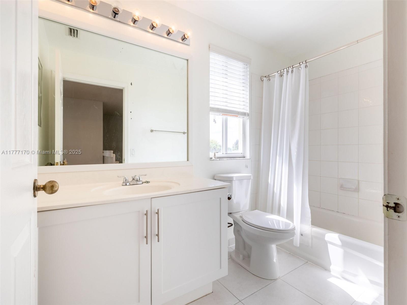 4242 Magnolia Ridge Drive Weston, FL 33331 - Photo 25 of 36 a bathroom with a sink a toilet and a mirror