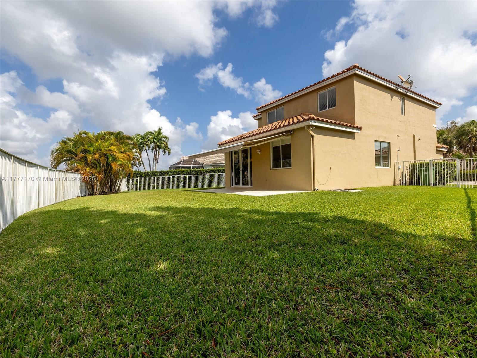 4242 Magnolia Ridge Drive Weston, FL 33331 - Photo 29 of 36 a view of a house with a yard