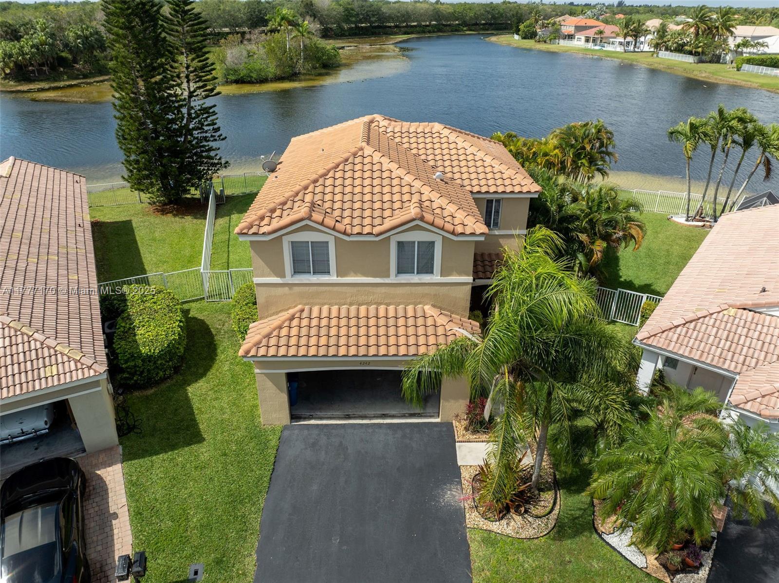 4242 Magnolia Ridge Drive Weston, FL 33331 - Photo 33 of 36 an aerial view of a house with a garden and lake view