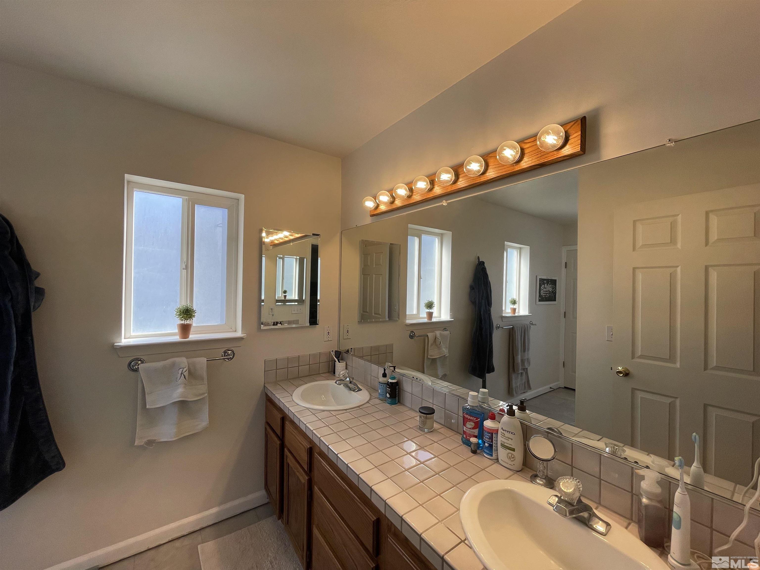 17 Mason Road Yerington, NV 89447 - Photo 11 of 36 a bathroom with double vanity and a mirror