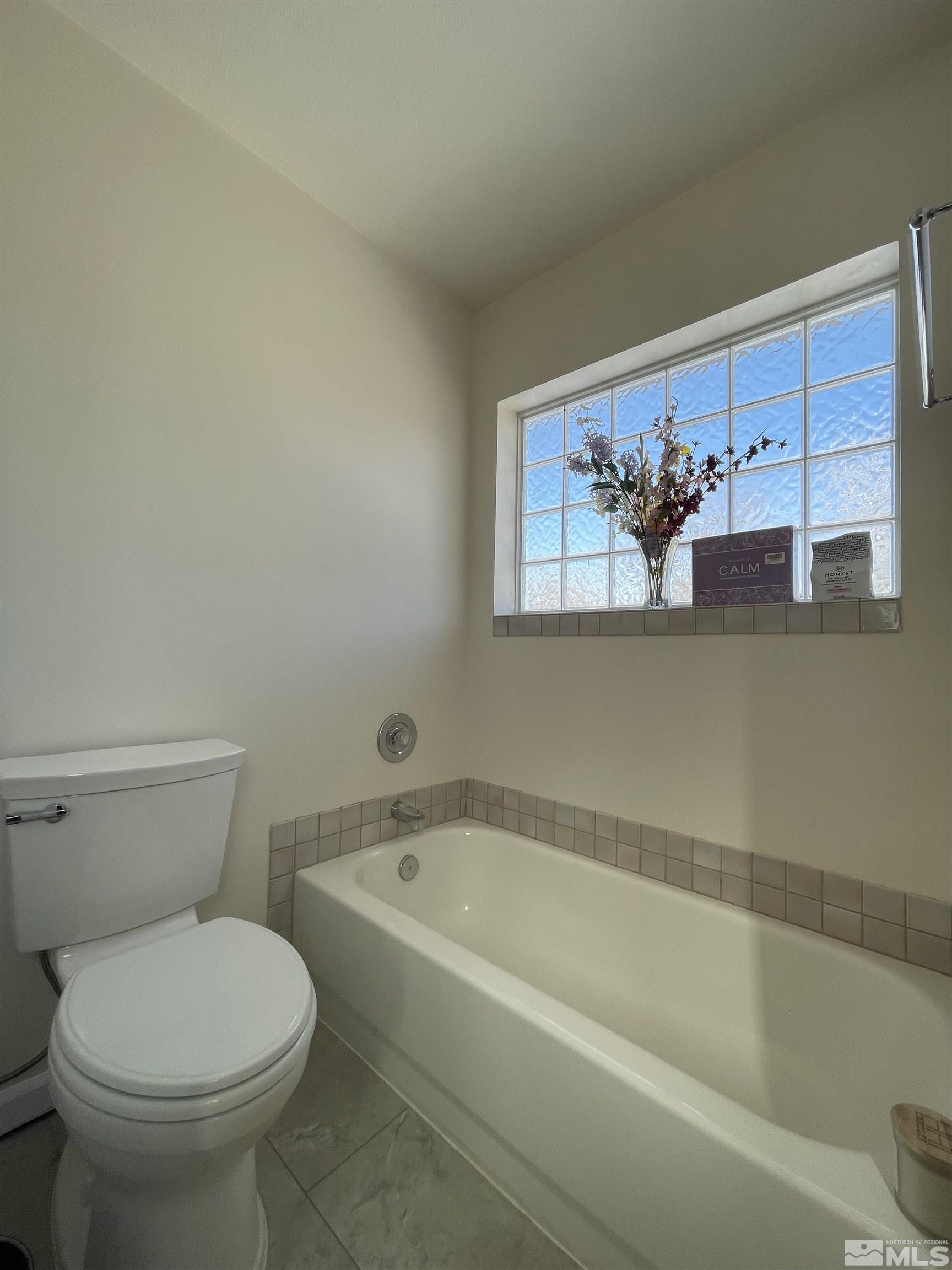 17 Mason Road Yerington, NV 89447 - Photo 12 of 36 a white toilet sitting next to a bathtub
