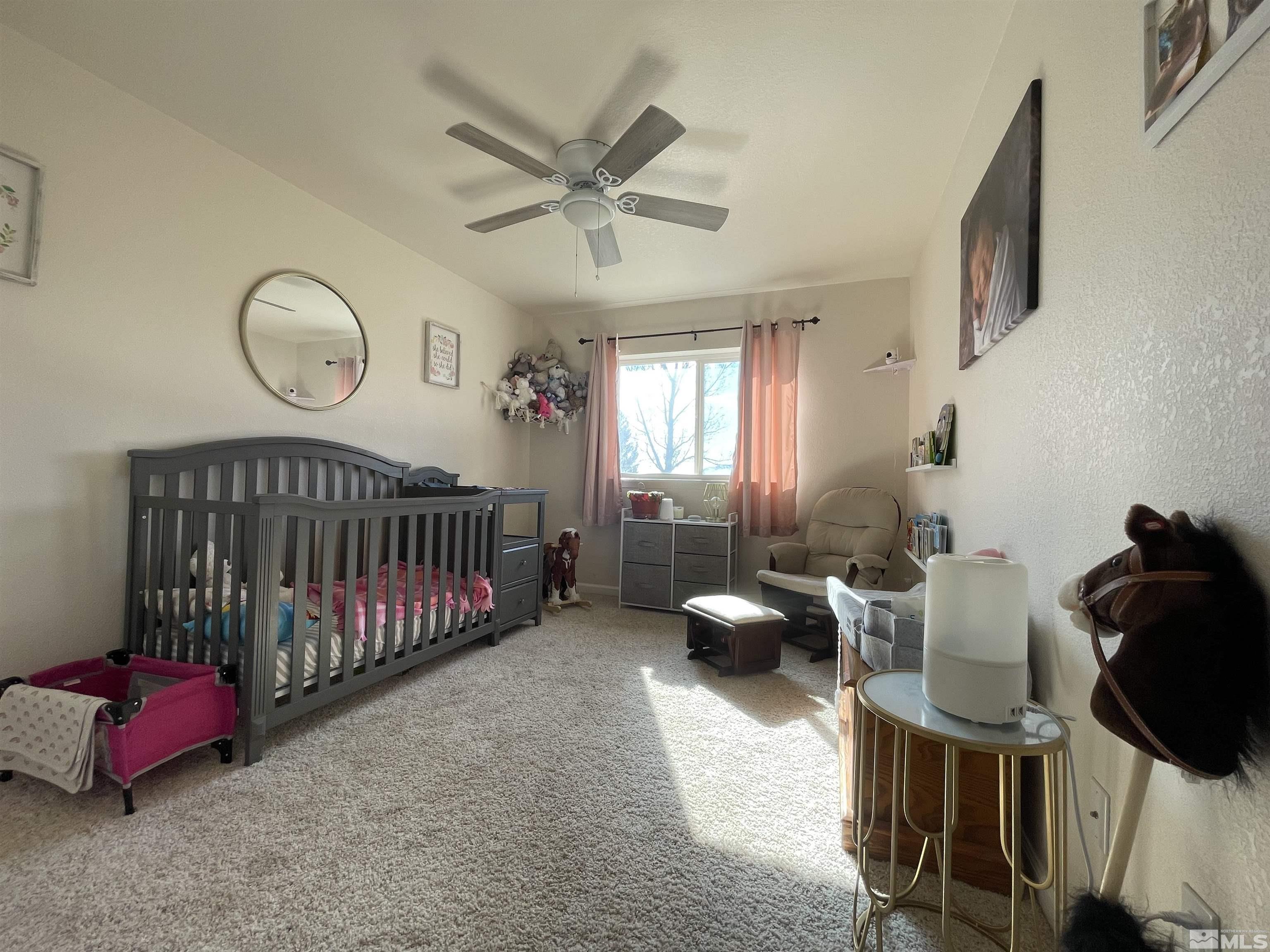 17 Mason Road Yerington, NV 89447 - Photo 15 of 36 a bedroom with furniture and a window