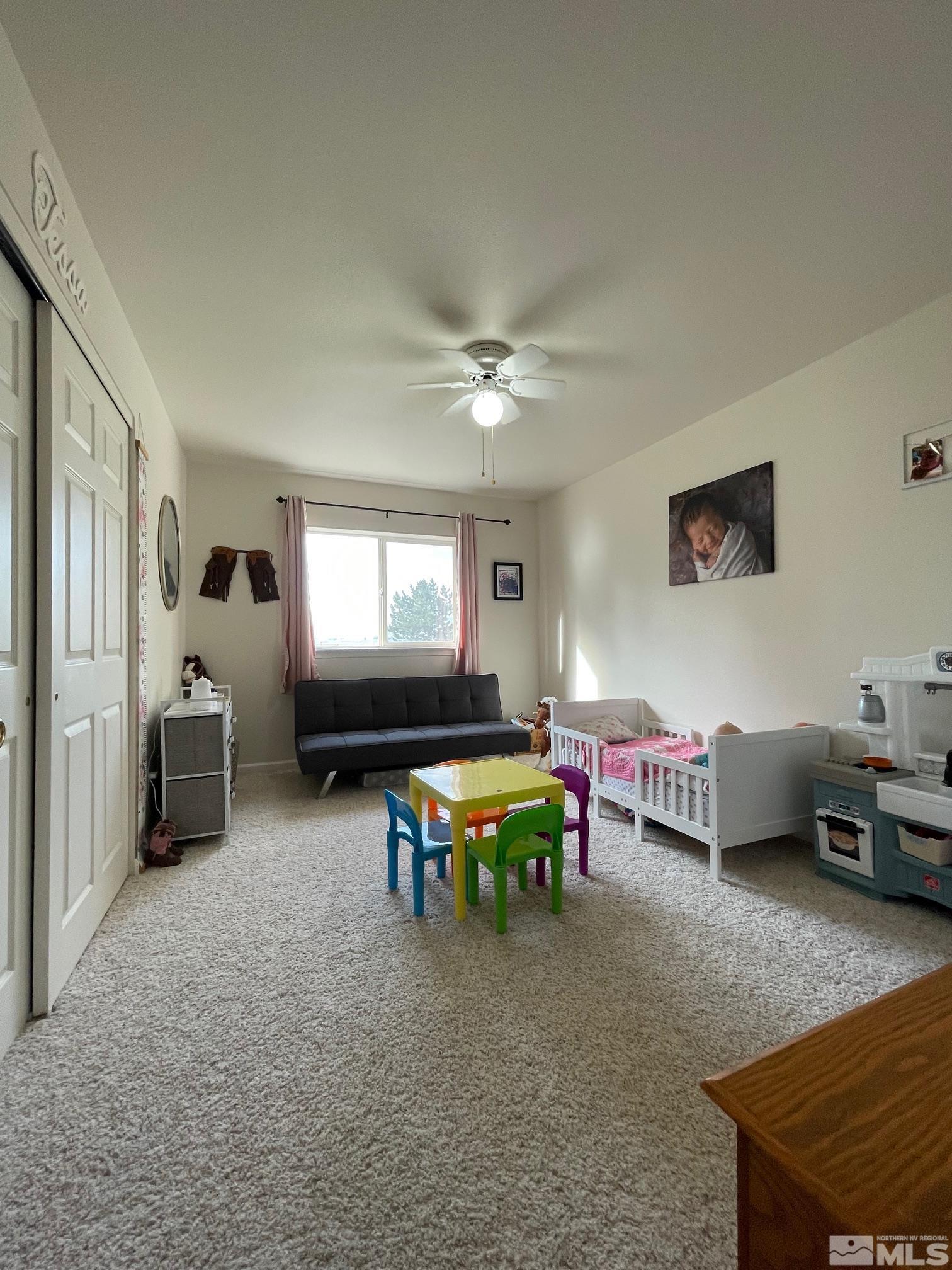 17 Mason Road Yerington, NV 89447 - Photo 17 of 36 a bedroom with furniture and a chair