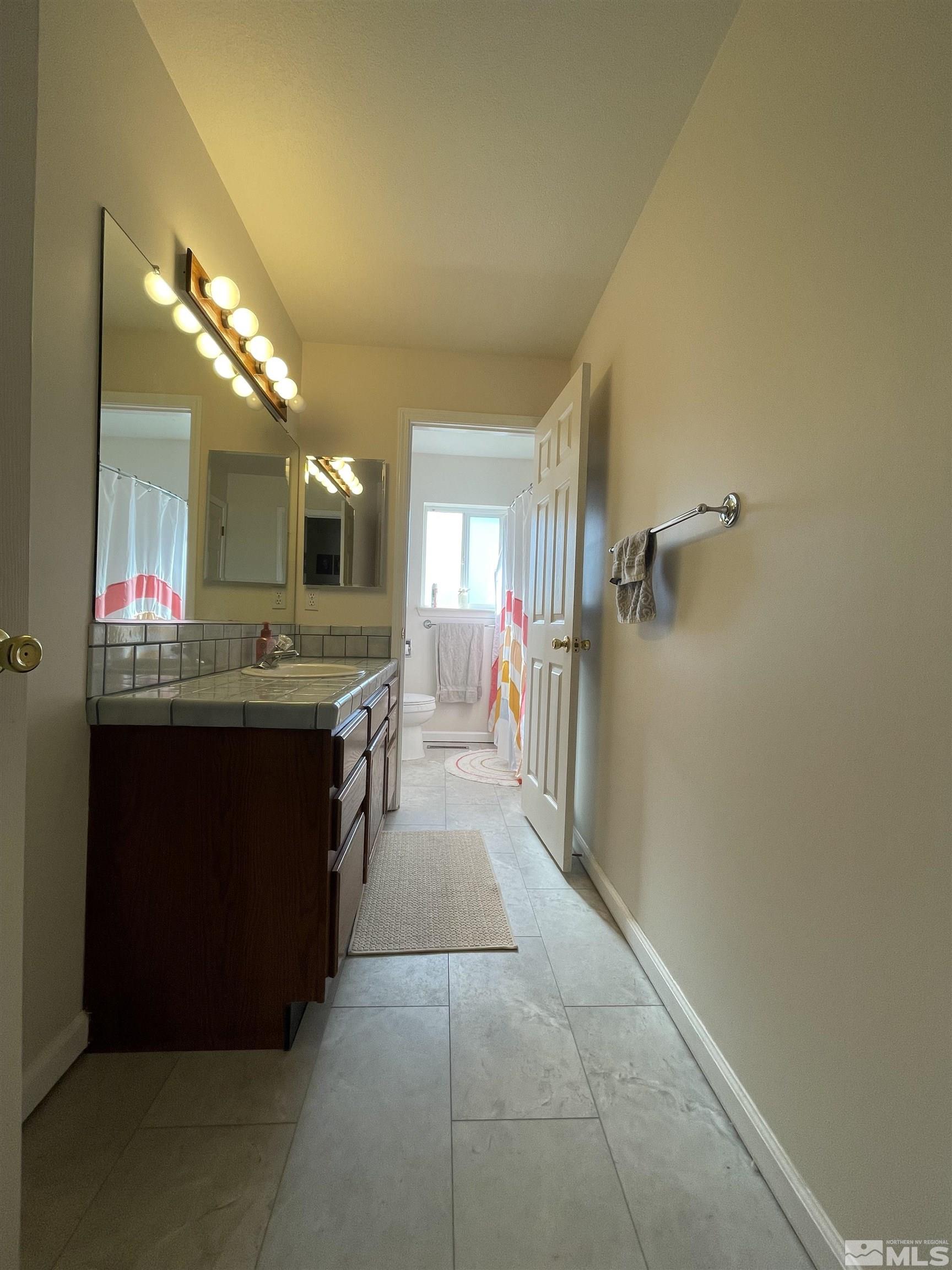 17 Mason Road Yerington, NV 89447 - Photo 19 of 36 a large bathroom with a sink a mirror and a shower