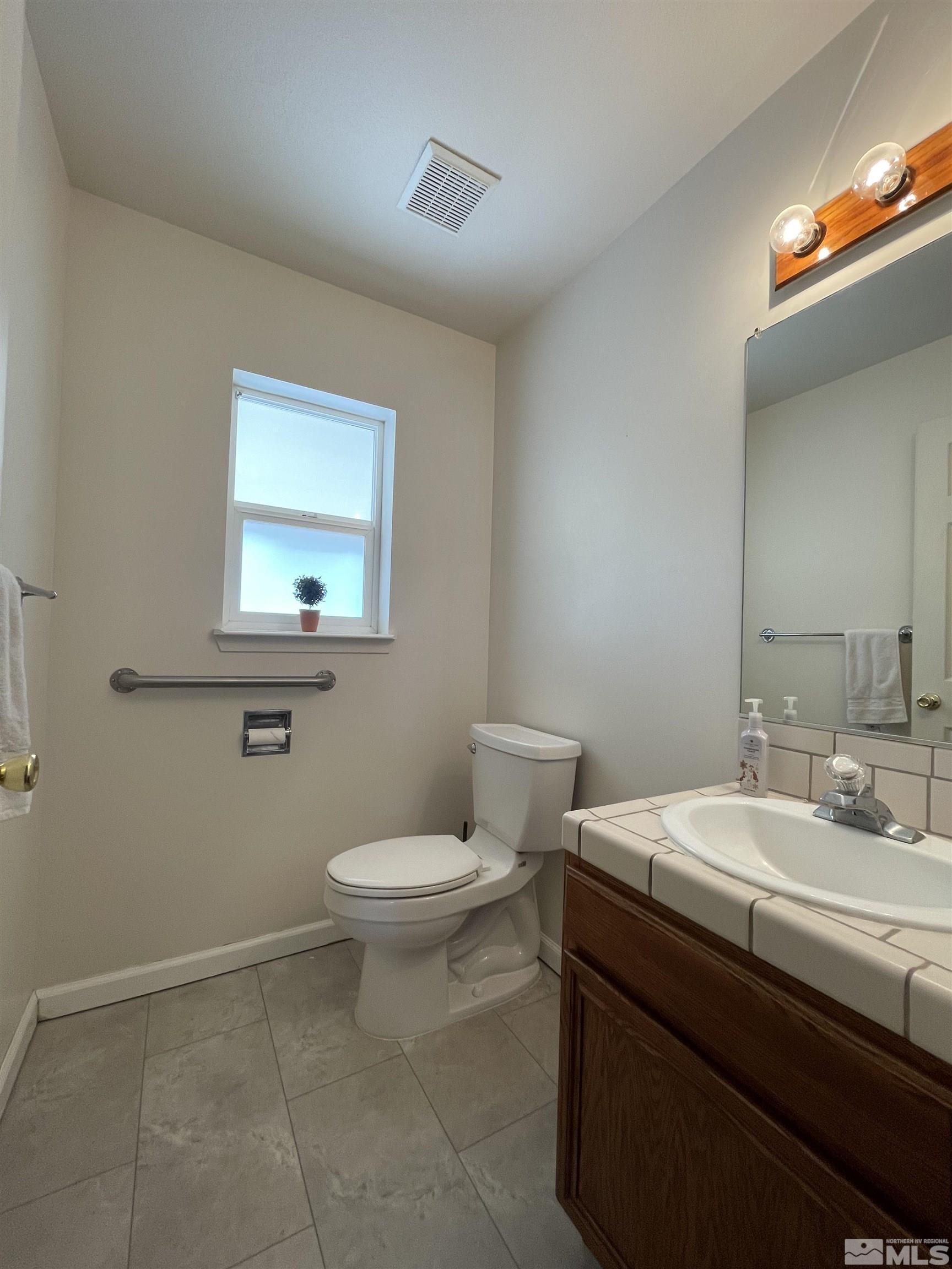 17 Mason Road Yerington, NV 89447 - Photo 20 of 36 a bathroom with a sink a toilet and mirror