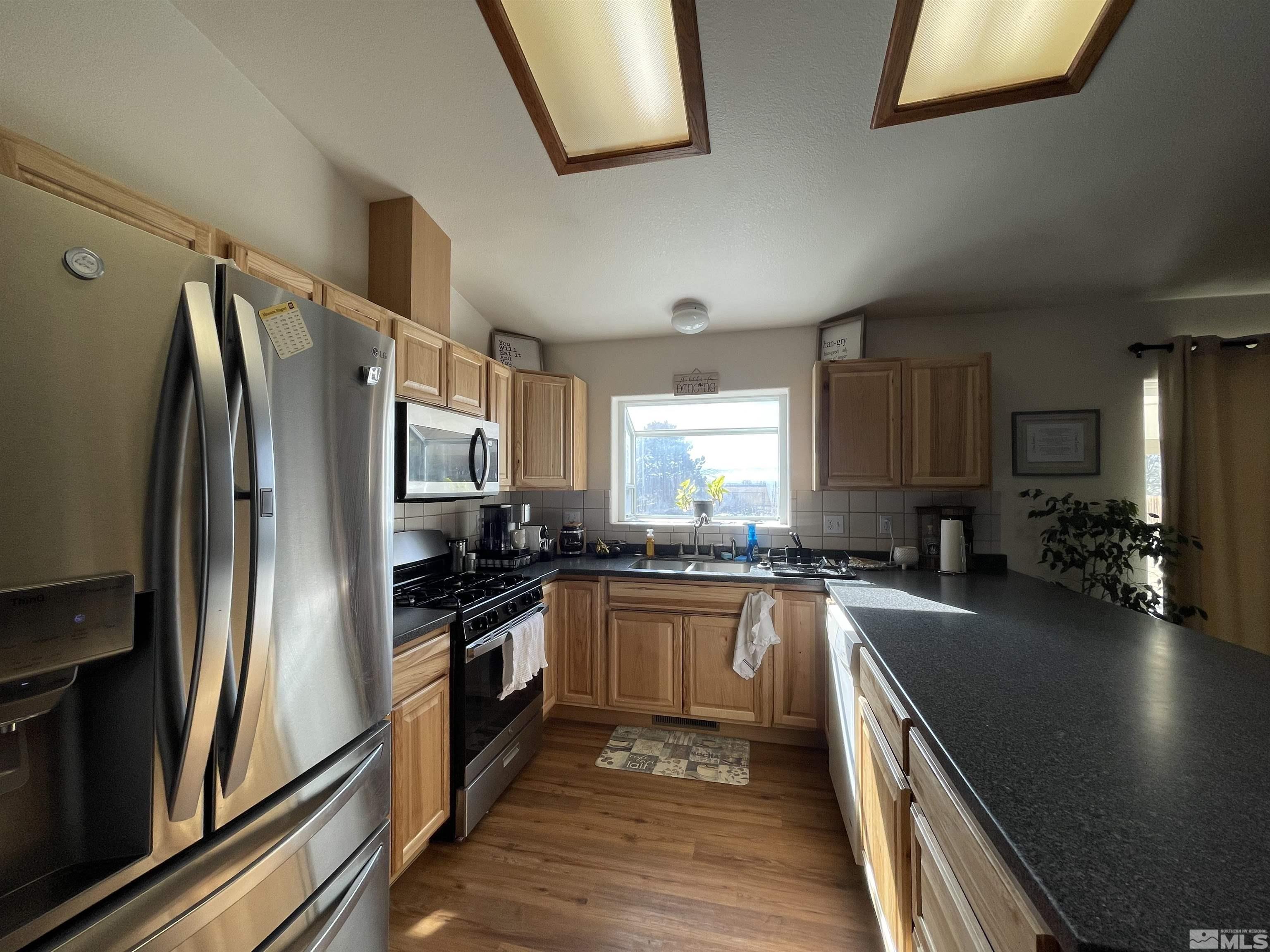 17 Mason Road Yerington, NV 89447 - Photo 8 of 36 a kitchen with granite countertop a refrigerator stove and sink