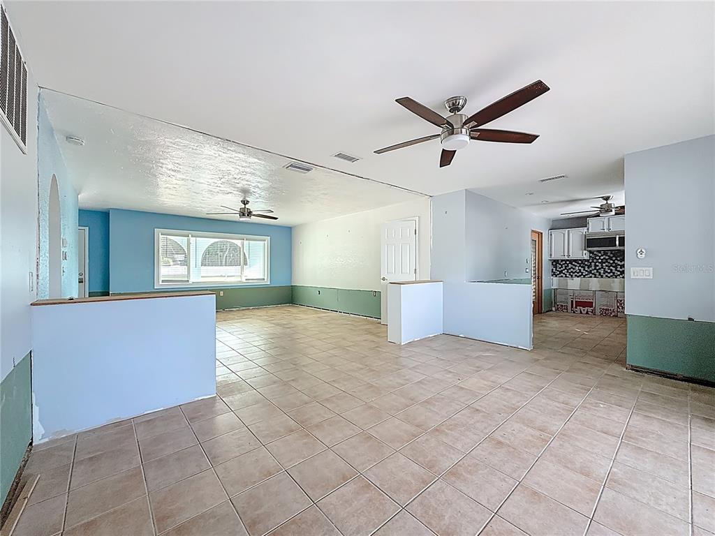4869 Shell Stream Boulevard New Port Richey, FL 34652 - Photo 17 of 46 a view of livingroom with hardwood floor and a ceiling fan
