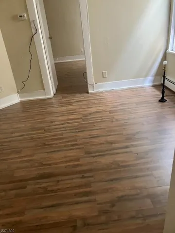 a view of room with wooden floor