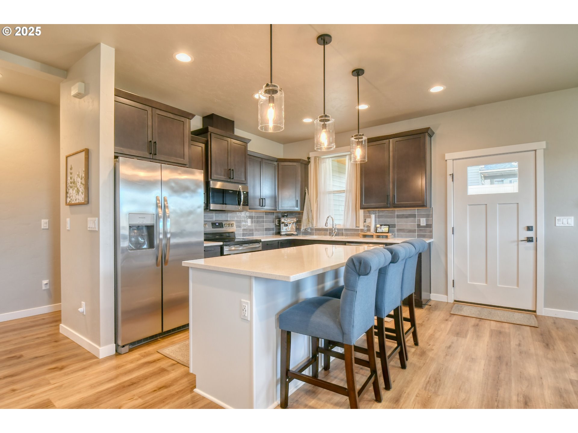 2 Lewis Circle Milton Freewater, OR 97862 - Photo 16 of 47 a kitchen with kitchen island granite countertop wooden floor and a refrigerator