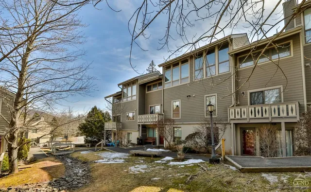 a front view of a building with parked cars