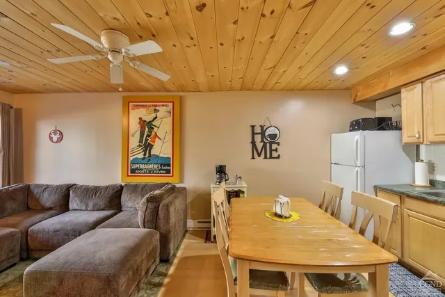 a living room with furniture a flat screen tv and a table
