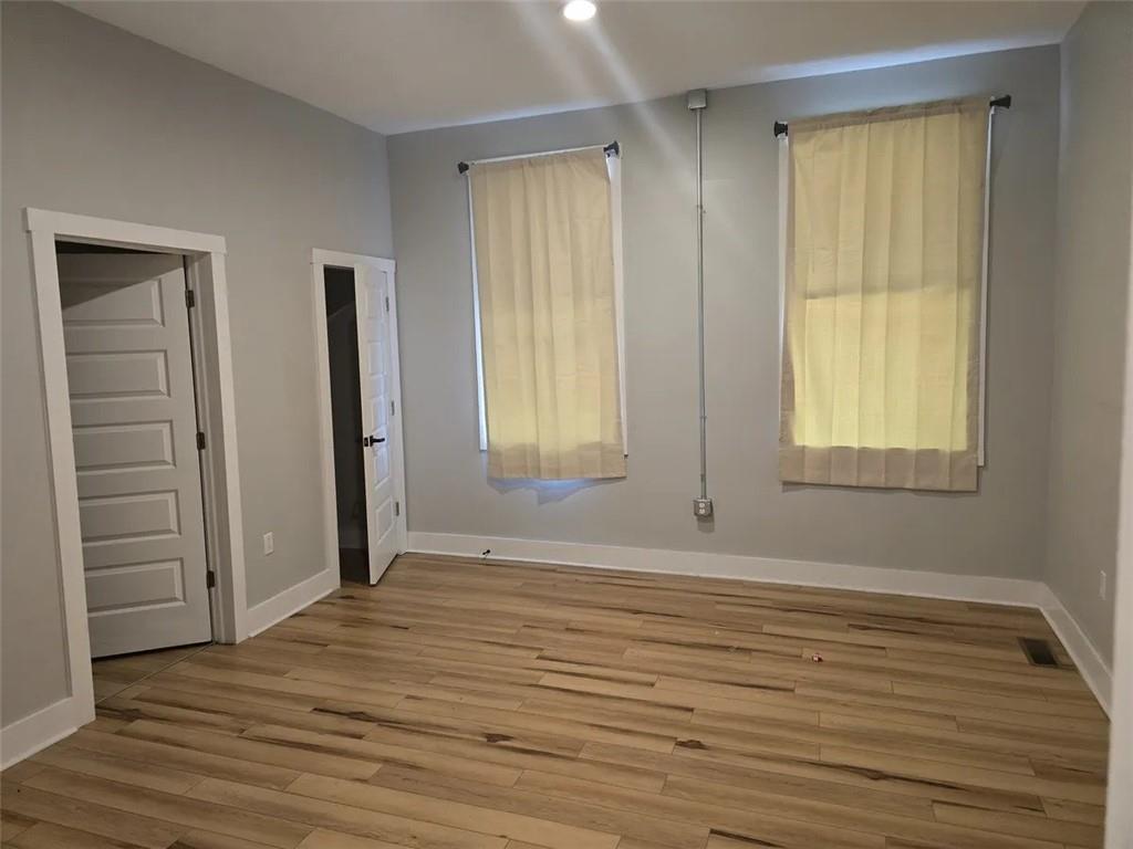 1117-1119 Spring Garden Avenue Pittsburgh, PA 15212 - Photo 18 of 27 an empty room with windows and closet