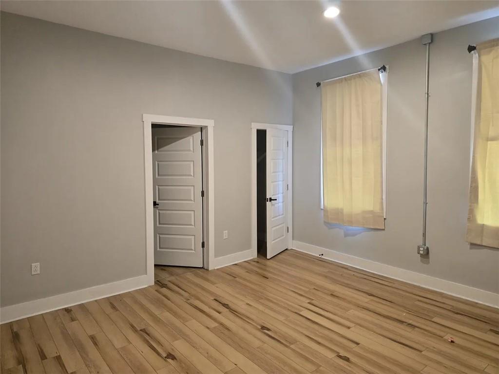 1117-1119 Spring Garden Avenue Pittsburgh, PA 15212 - Photo 19 of 27 an empty room with wooden floor and windows