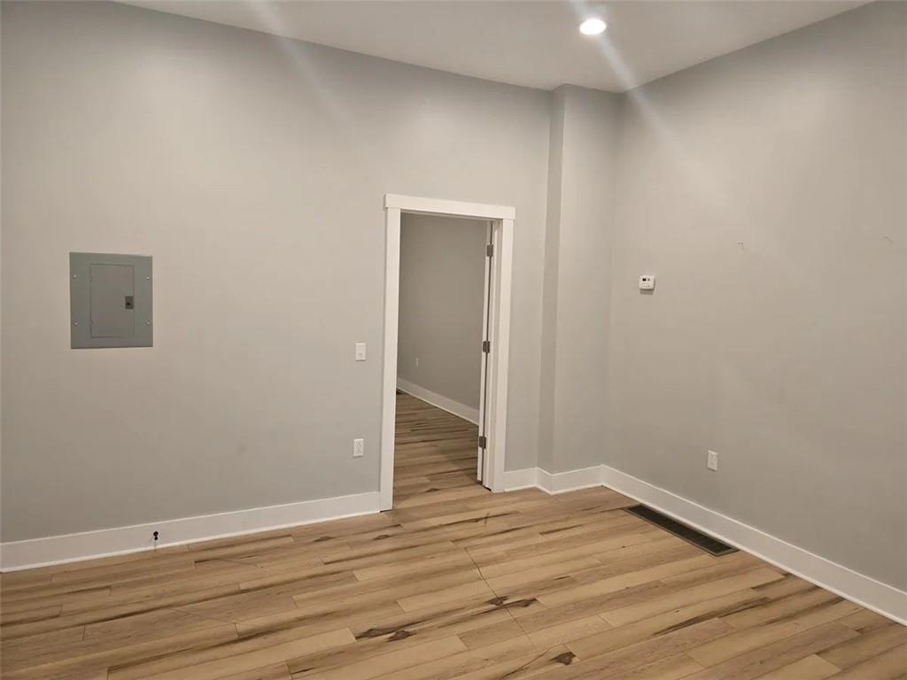 1117-1119 Spring Garden Avenue Pittsburgh, PA 15212 - Photo 24 of 27 a view of an empty room with wooden floor