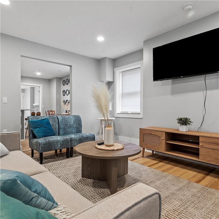 1117-1119 Spring Garden Avenue Pittsburgh, PA 15212 - Photo 4 of 27 a living room with furniture and a flat screen tv