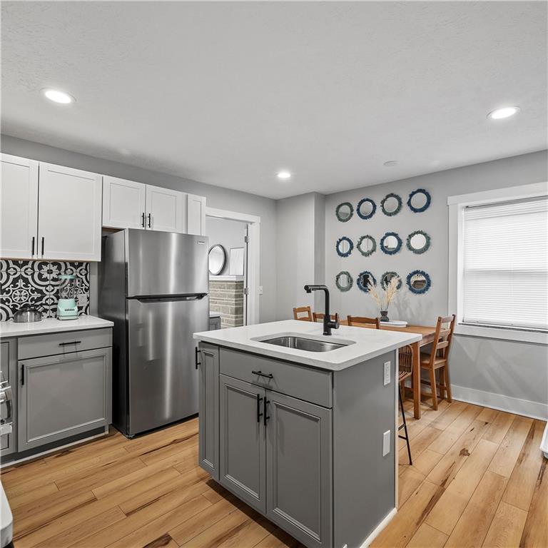 1117-1119 Spring Garden Avenue Pittsburgh, PA 15212 - Photo 8 of 27 a kitchen with stainless steel appliances granite countertop a sink stove and refrigerator