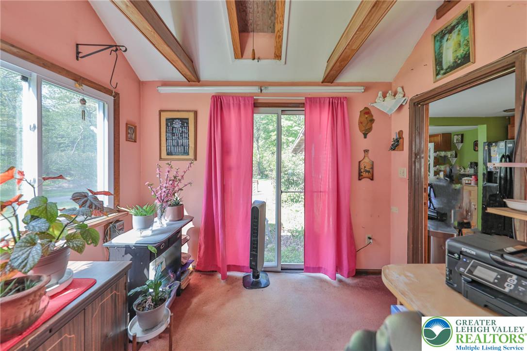 331 Cranberry Creek Road Cresco, PA 18326 - Photo 62 of 95 Exposed beams complement a window-filled living area with backyard access.