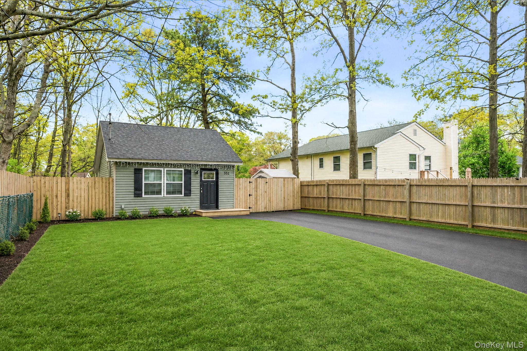 332 Commack Road Shirley, NY 11967 - Photo 3 of 25 a view of a house with a yard and a large tree