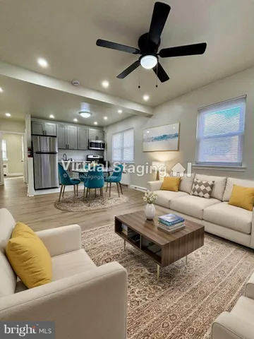 a living room with furniture and kitchen view
