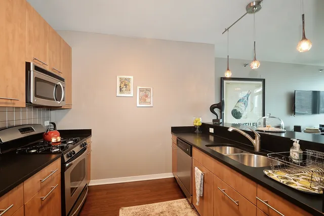 a kitchen with a sink stove and microwave