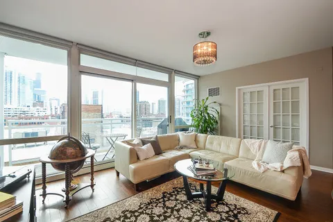 a living room with furniture and a floor to ceiling window