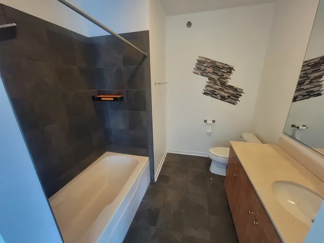 a bathroom with a bathtub and shower