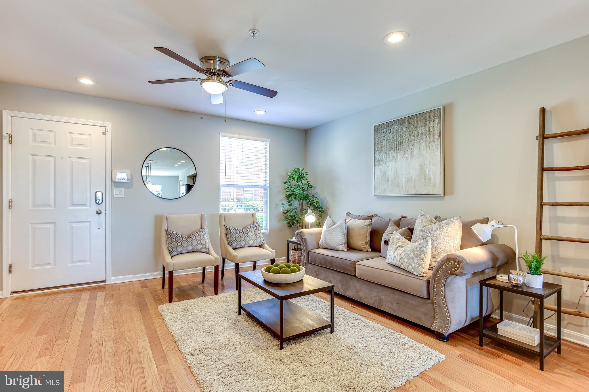 4603 Dillon Street Baltimore, MD 21224 - Photo 6 of 35 Living Room w/ Hardwood Floors & Ceiling Fan