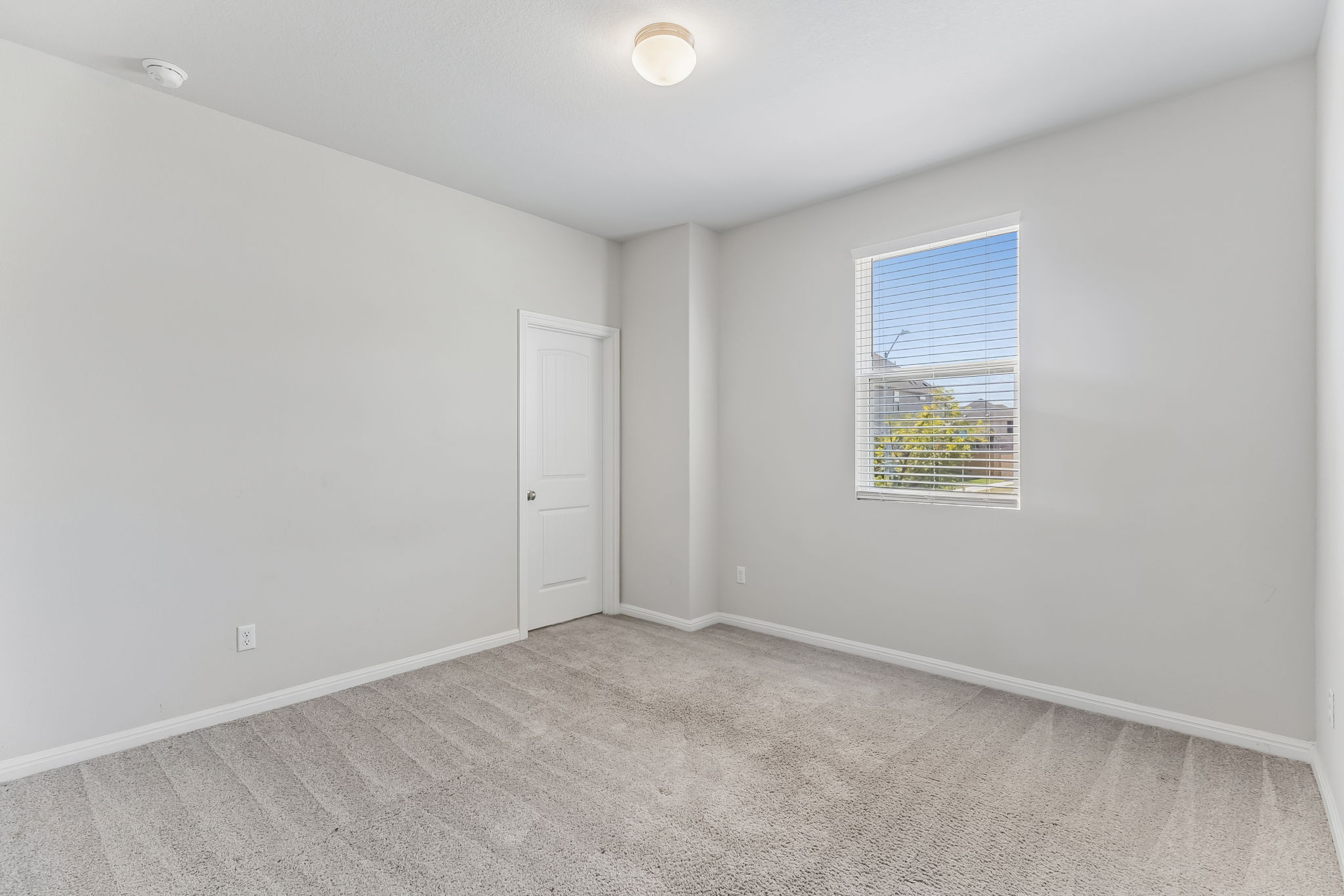 4009 Milano River Road Hutto, TX 78634 - Photo 28 of 40 Plush carpeting and a large window define this versatile bedroom.