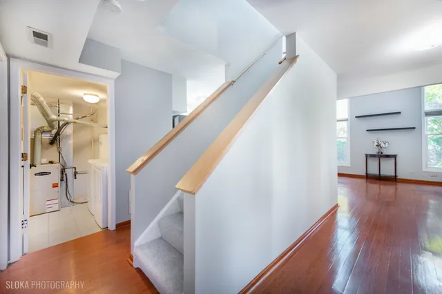 a view of a hallway view with wooden floor and staircase