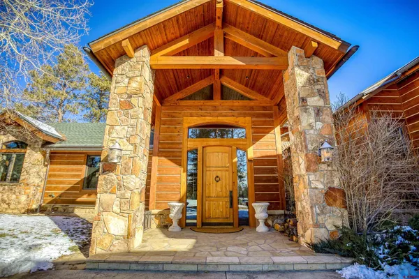 a view of a dining room with furniture large windows and wooden floor