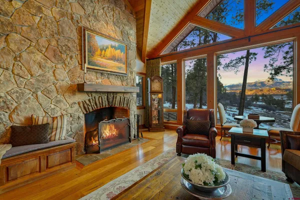 a kitchen with stainless steel appliances granite countertop a stove a sink dishwasher and a refrigerator with wooden floor