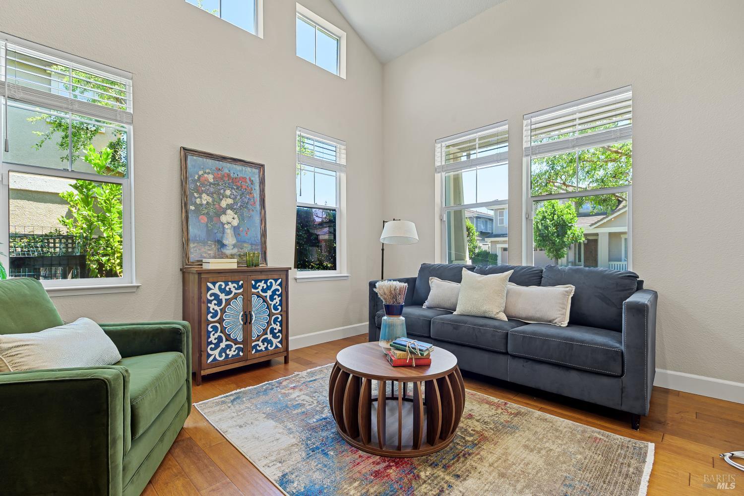 68 Pinheiro Circle Novato, CA 94945 - Photo 7 of 82 Vaulted ceilings and oversized windows bring exceptional volume and natural light to this inviting living room. It's a bright, comfortable space designed for both quiet mornings and relaxed evenings.