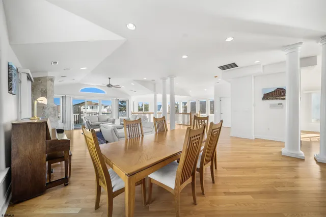 a dining room with furniture and wooden floor